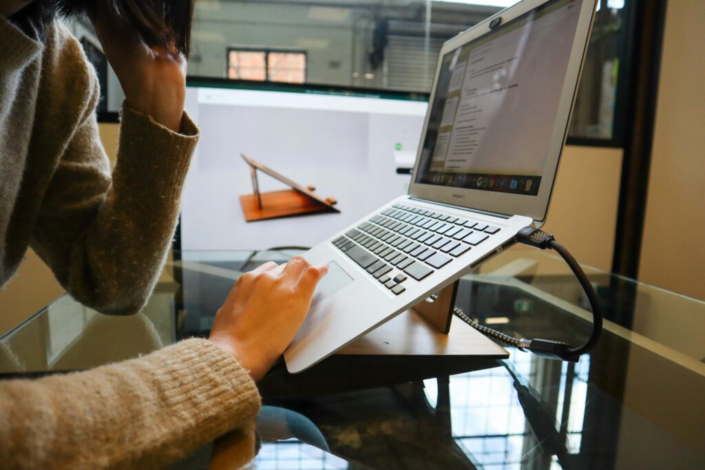 Adjustable ergonomic laptop stand on a desk for remote workers