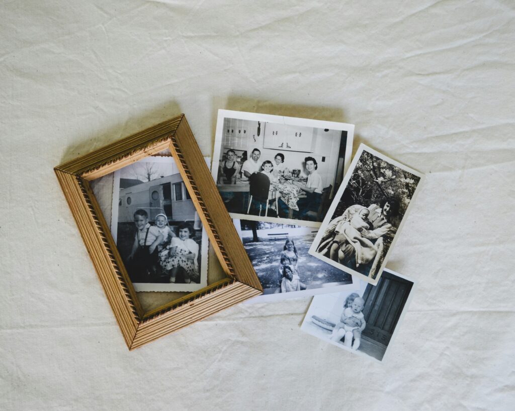 Wall-mounted photo collage frame filled with family pictures