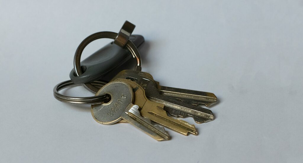 Tile Bluetooth tracker keychain attached to a set of house keys